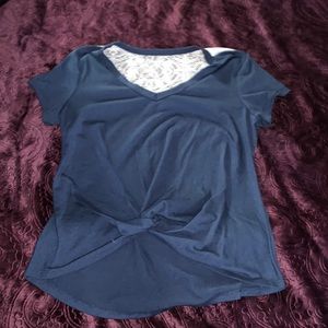 A navy blue shirt, with lace on the back.